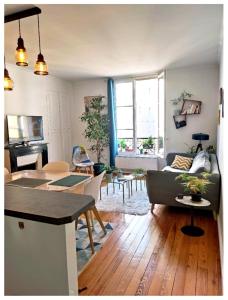 a living room with a couch and a table at Cosy apartment PARIS XIIème in Paris