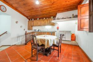 a kitchen with a table and chairs in it at Casa da Celeira in Ponte de Lima