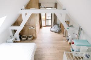 a loft bedroom with a bed and wooden floors at Lodge op de Berg in Bree +39 photos