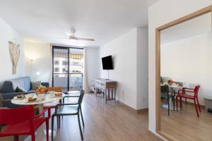 a living room and dining room with a table and chairs at Summerland FREE WIFI in Los Cristianos