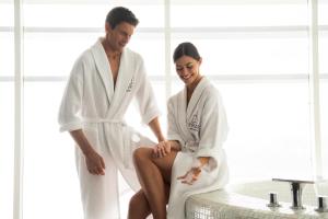 a man and a woman in a bath room at MYRIAD by SANA Hotels in Lisbon