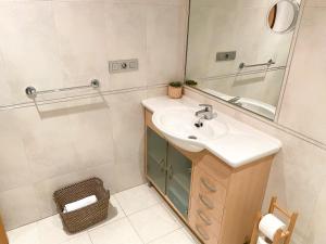 a bathroom with a sink and a mirror at Apartamento acogedor con vistas al mar. in A Coruña +21 photos