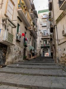 an alley in an old town with stairs at Casa vacanza russo enzo in Naples