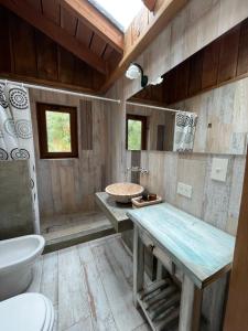 a bathroom with a sink and a toilet at Hogar de Montaña in Villa La Angostura