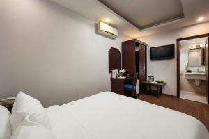 Ein Bett oder Betten in einem Zimmer der Unterkunft Cristina Center Hotel & Spa