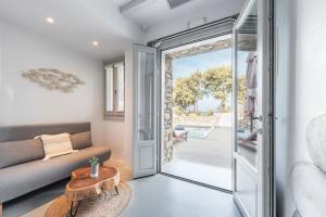 a living room with a couch and a table at Paros Comfy Suites in Naousa