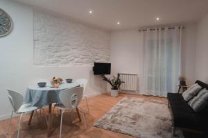 a living room with a table and a couch at Apartamento Zurriola by SanSe Holidays in San Sebastián