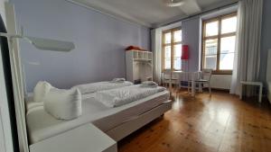 a white room with two beds and a table at Hotel Cranach-Herberge City Centre in Lutherstadt Wittenberg +144 photos