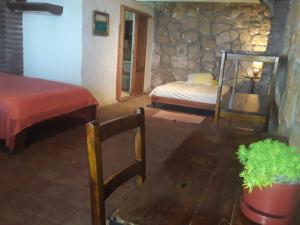 a room with a bed and a table with a table sidx sidx sidx at Maremonti Vacation Rental in Puerto López