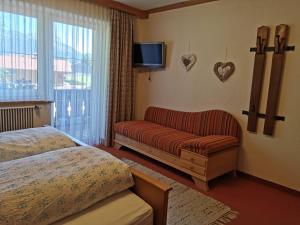 A bed or beds in a room at Pension Tannheim