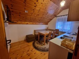 a kitchen and dining room with a table and a stove at Apartments Đurđić in Žabljak