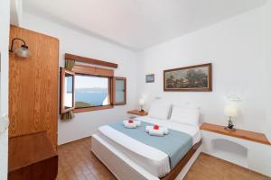 Postel nebo postele na pokoji v ubytování Kounenos Apartments