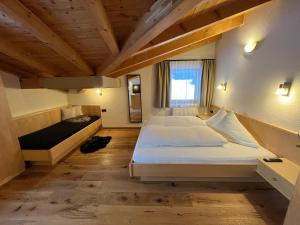 a bedroom with a large bed and a window at Ferienhaus Ragg in Kaunertal