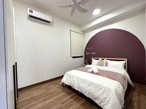a bedroom with a large bed and a ceiling fan at The Apple PREMIER CONDO three bedroom in MELAKA in Malacca