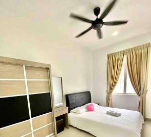 - une chambre avec un lit et un ventilateur de plafond dans l'établissement D’Royale Desaru Homestay, à Bandar Penawar