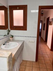 a bathroom with a sink and a hallway at Chalet con piscina Sa Ràpita in Sa Ràpita