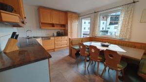 a kitchen with a table and chairs and a window at Easy Home Johanna - Central Kirchberg in Kirchberg in Tirol