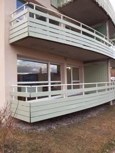 a house with a large balcony on the side of it at BALCONS du LAC in Gérardmer