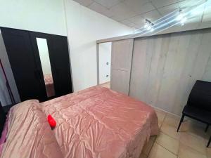 a bedroom with a pink bed and a chair at Holiday Studio Castel di Sangro in Castel di Sangro