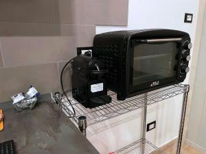 a microwave sitting on a rack next to a counter at Holiday Studio Castel di Sangro in Castel di Sangro