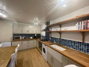 a kitchen with a sink and a dishwasher at Harbourside Apartment in Eyemouth