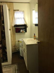 a small bathroom with a sink and a mirror at O Me, O Mio Cabin near the AuSable River in Mio