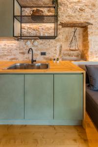 a kitchen with a sink and a wooden counter at Casa Coo in Dhafnédhes