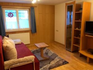 a living room with a couch and a table at Haus Konzett in Klösterle