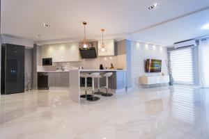 a kitchen with a bar with stools in it at Luxury 2 bedroom apartment in Los Cristianos in Los Cristianos