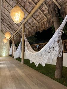 a hammock hanging from a thatched ceiling at Ronco do Mar Jeri in Jericoacoara