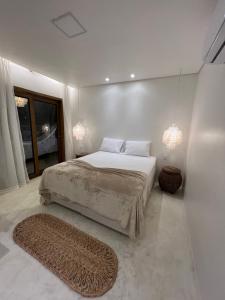 a bedroom with a large bed and a large window at Ronco do Mar Jeri in Jericoacoara
