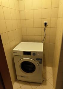 a washer and dryer in a small room at Private Room In shared apartment in heart of Ajman in Ajman 