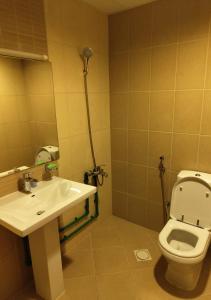 a bathroom with a toilet and a sink at Private Room In shared apartment in heart of Ajman in Ajman 