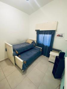 a bedroom with a bed in the corner of a room at Casa Daval solo Familias in Villa Carlos Paz