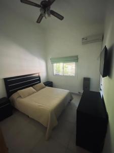 um quarto com uma cama e uma ventoinha de tecto em Casa Daval solo Familias em Villa Carlos Paz