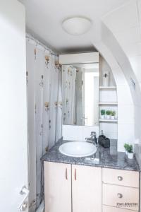 a bathroom with a sink and a mirror at Temple mount view in Yerushalayim