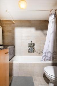 a bathroom with a bath tub and a toilet at Temple mount view in Yerushalayim