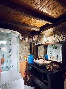 a bathroom with a sink and a shower at Little Stone Villa in Kírki