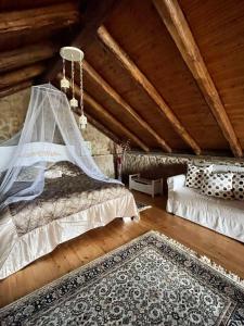 a attic room with two beds and a rug at Little Stone Villa in Kírki