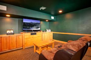 a living room with a couch and a large screen tv at The Springs Condominiums by Keystone Resort in Keystone