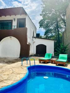 a swimming pool in front of a house at Casa Calo Bialet Massé in Bialet Massé