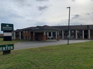 a hotel with a sign in front of a building at HomeTowne Studios by Red Roof Egg Harbor-Atlantic City Airport in Egg Harbor Township