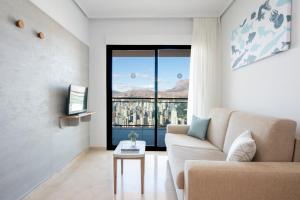 uma sala de estar com um sofá e uma grande janela em Pierre & Vacances Apartamentos Benidorm Horizon em Benidorm