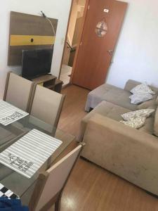 a living room with a couch and a table at APT A 10 MIN DA CIDADE DE PENEDO in Resende