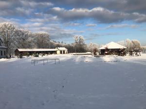 a snow covered parking lot with a snow covered field at Kantonia in Bobolice