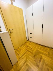 a room with two doors and a wooden floor at Condo 21 in Belgrade +10 photos