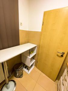 a small kitchen with a counter and a door at Condo 21 in Belgrade