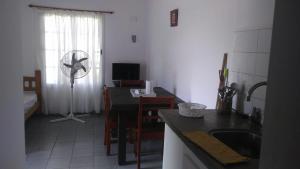 a kitchen with a sink and a table with a fan at Boa Vida in Gualeguaychú