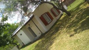 a house with a tree in front of it at Boa Vida in Gualeguaychú