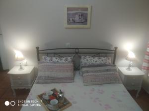 a bedroom with a bed with two night stands at Τhalassa Home Fine Living in Petra